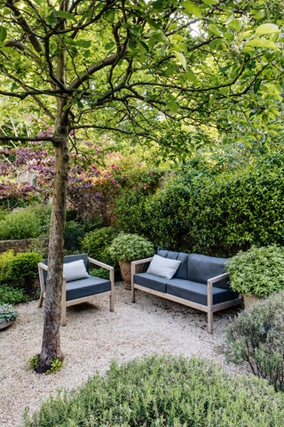 Image may contain Outdoors Furniture Couch Garden Yard Nature Arbour Bench and Backyard