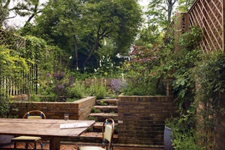 Image may contain Furniture Chair Outdoors Garden Flagstone Arbour and Patio