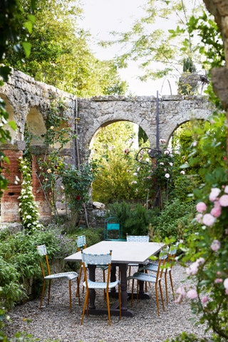 Image may contain Furniture Chair Outdoors Garden Dining Table Table Patio Arbour Housing Villa and House
