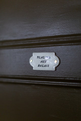 As part of her own collection Alix sells small porcelain signs and this one which says ‘broom cupboard stands out...