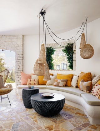 A dreamy villa in Corfu designed by Martin Hulbert features a builtin seating area in the shade. It's enlivened by a...