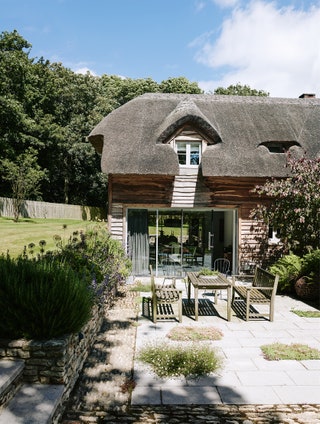 Image may contain Cottage Housing House Building Patio Outdoors Flagstone and Garden