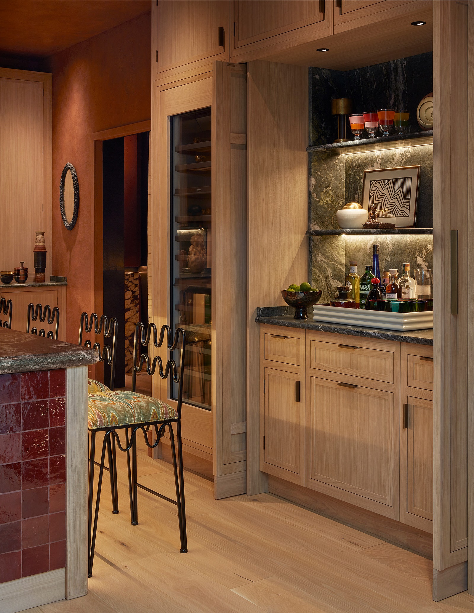 Image may contain Indoors Interior Design Shelf Art Painting Chair Furniture Kitchen Floor Wood Candle and Closet